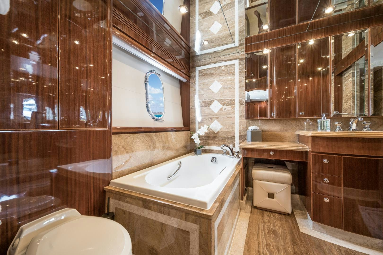 a bathroom with a tub sink and toilet aboard LIMITLESS Yacht for Sale