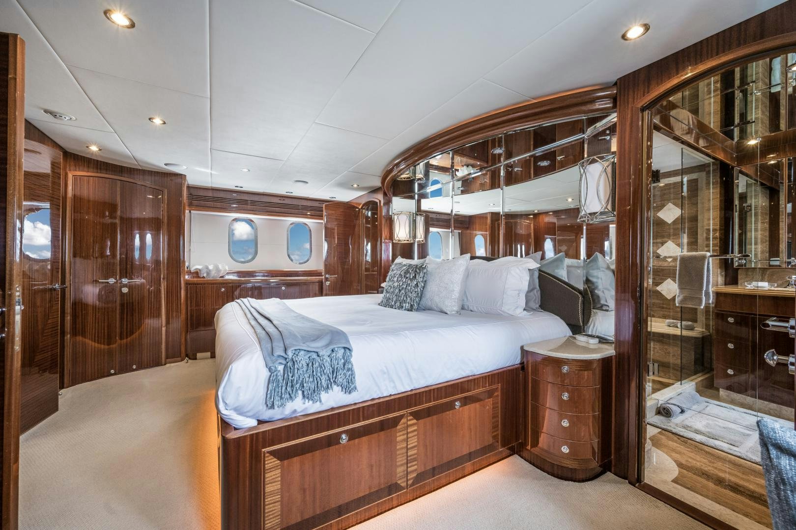 a bedroom with a bed and a mirror aboard LIMITLESS Yacht for Sale