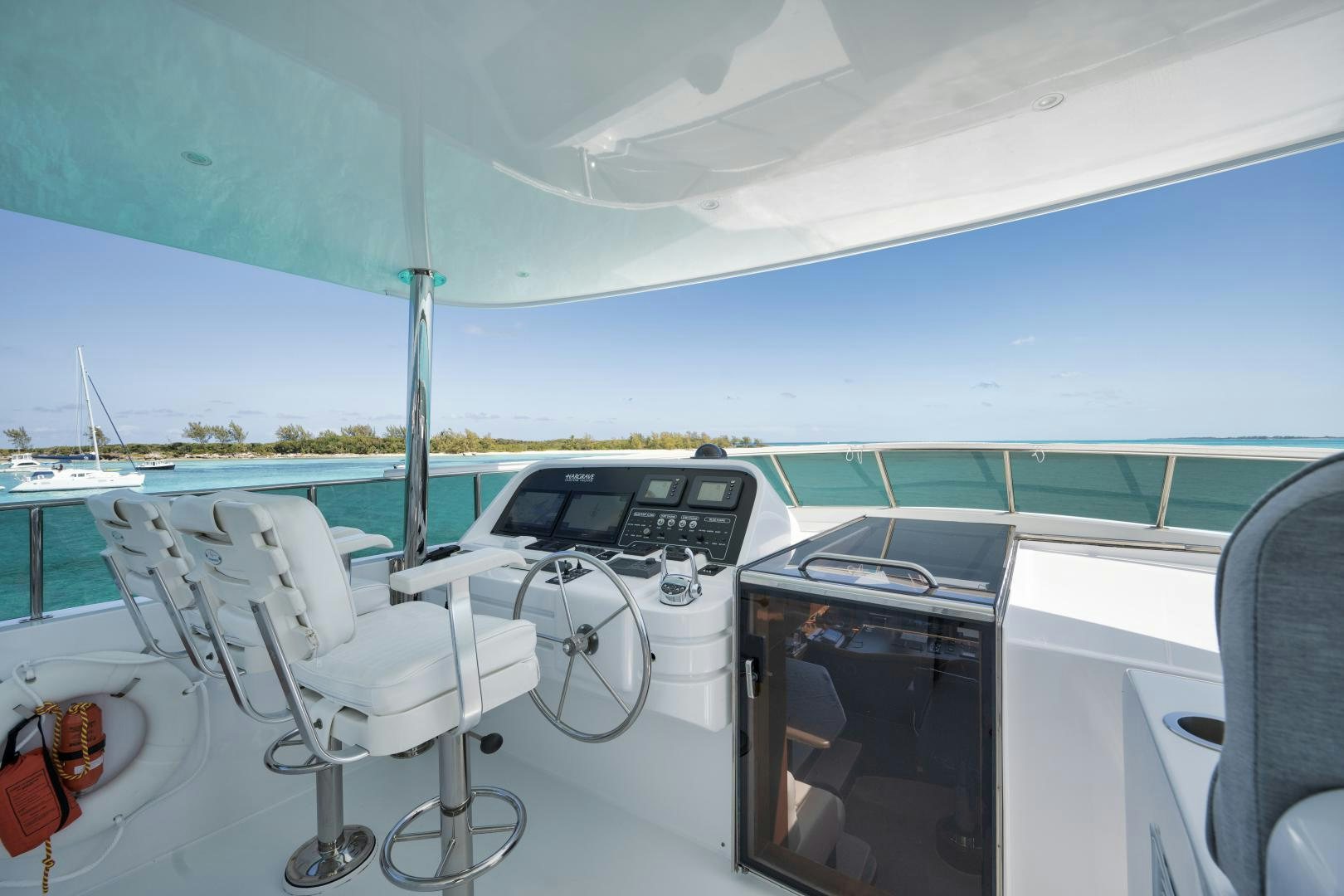 a boat with a deck and chairs aboard LIMITLESS Yacht for Sale