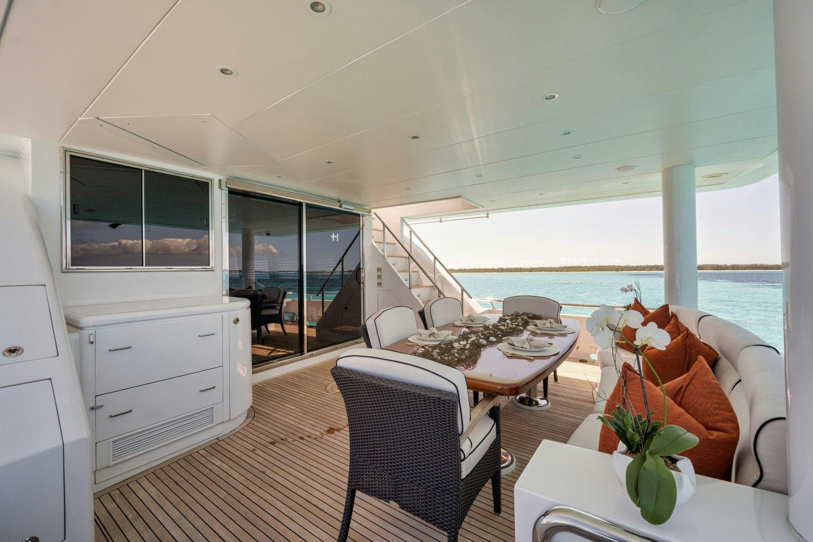 a living room with a large balcony aboard LIMITLESS Yacht for Sale