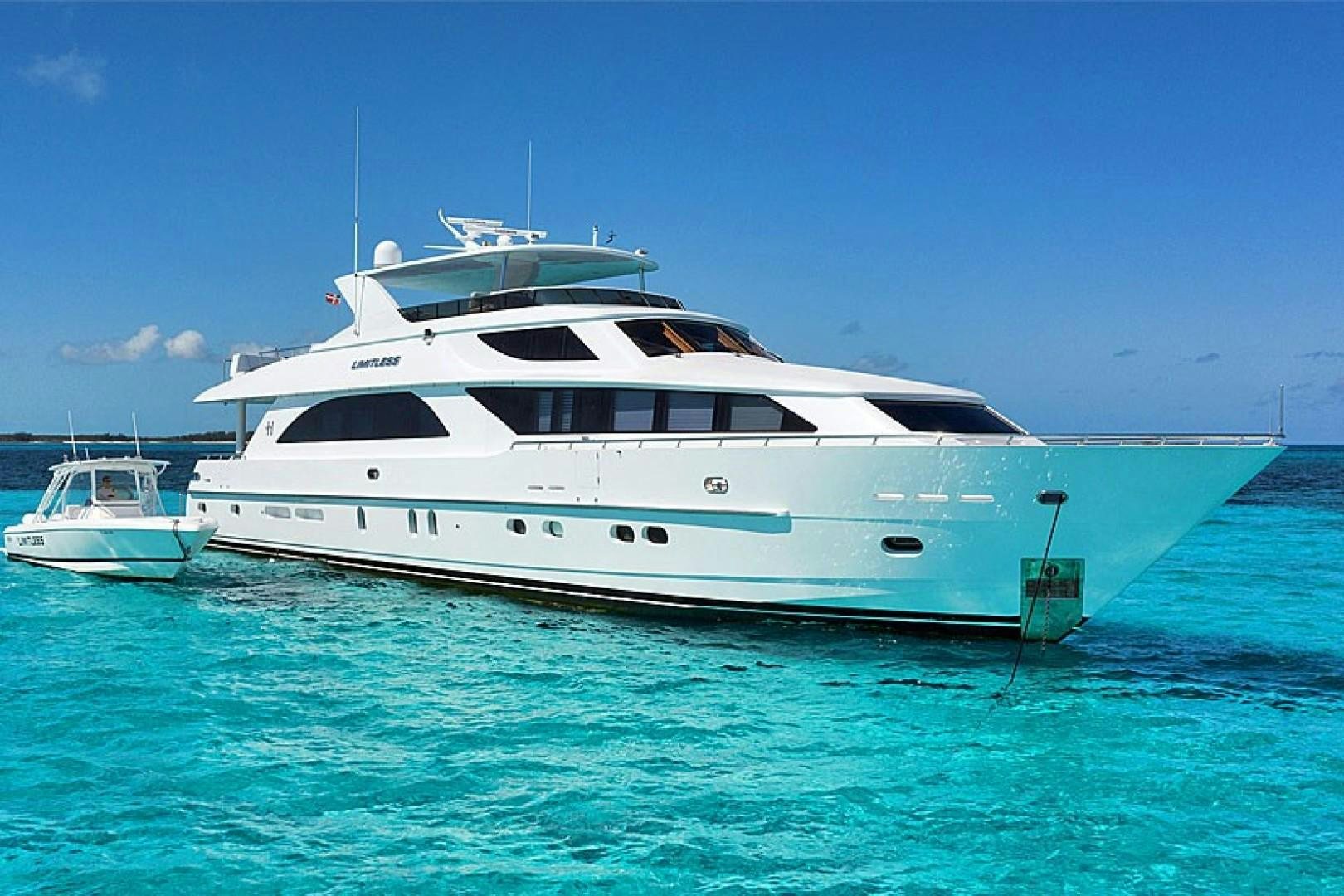 a white yacht in the water aboard LIMITLESS Yacht for Sale