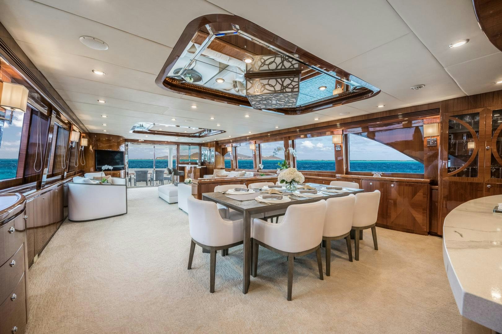 a large room with tables and chairs aboard LIMITLESS Yacht for Sale