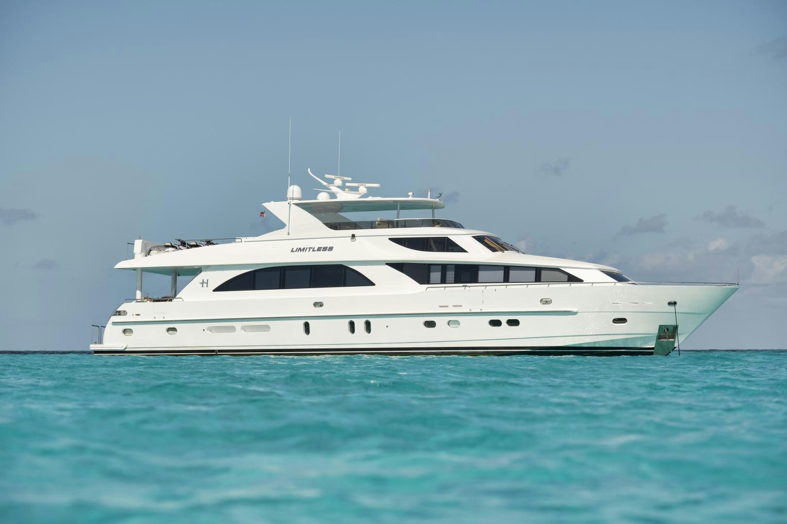 a white yacht in the water aboard LIMITLESS Yacht for Sale