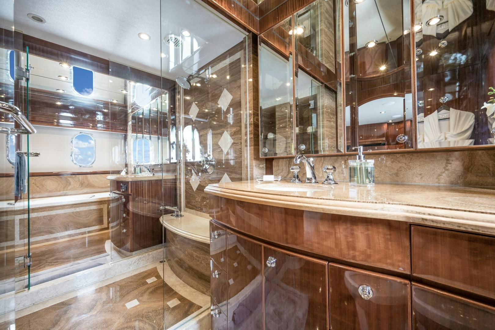 a bathroom with a large mirror aboard LIMITLESS Yacht for Sale