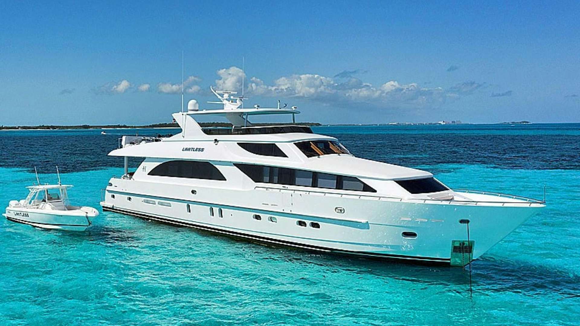 a white yacht in the water aboard LIMITLESS Yacht for Sale