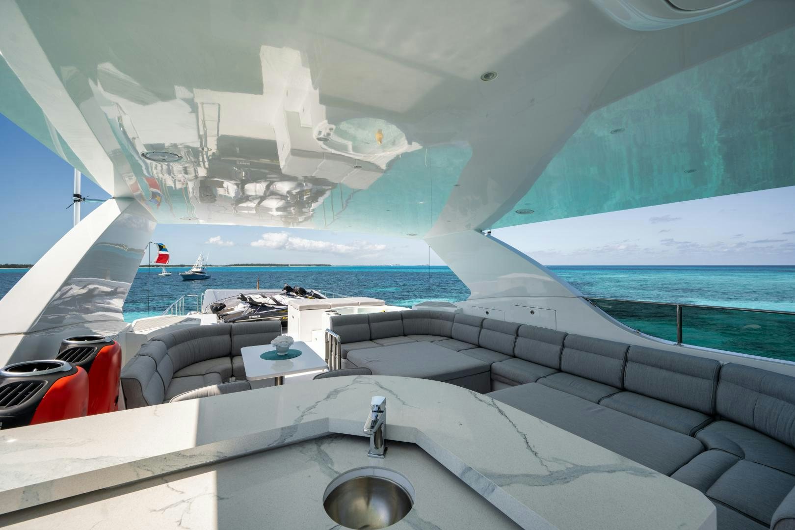 a large white and blue room with a sink and a large swimming pool aboard LIMITLESS Yacht for Sale