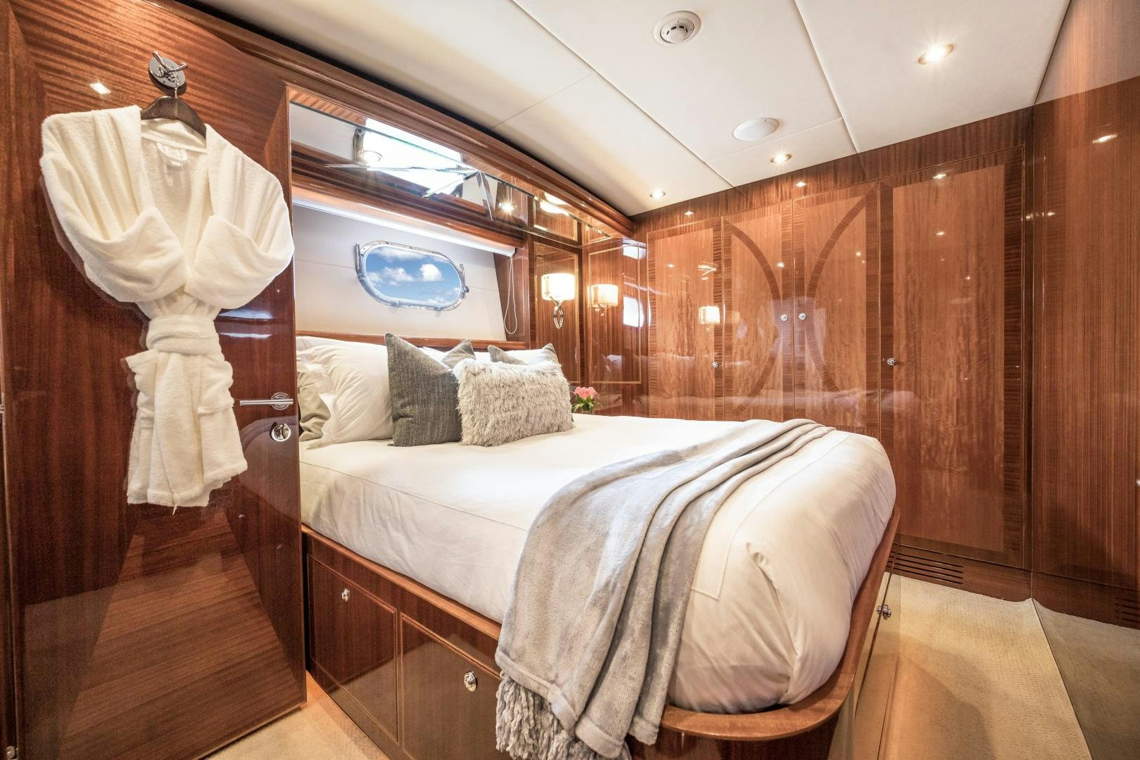 a room with a bed and a mirror aboard LIMITLESS Yacht for Sale