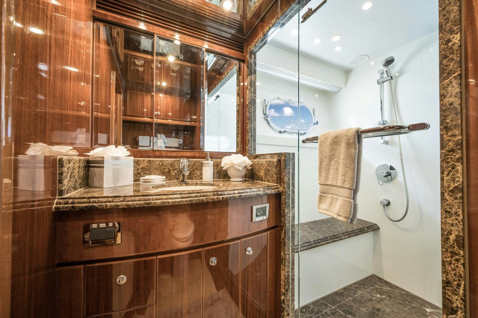 a bathroom with a sink and mirror aboard LIMITLESS Yacht for Sale