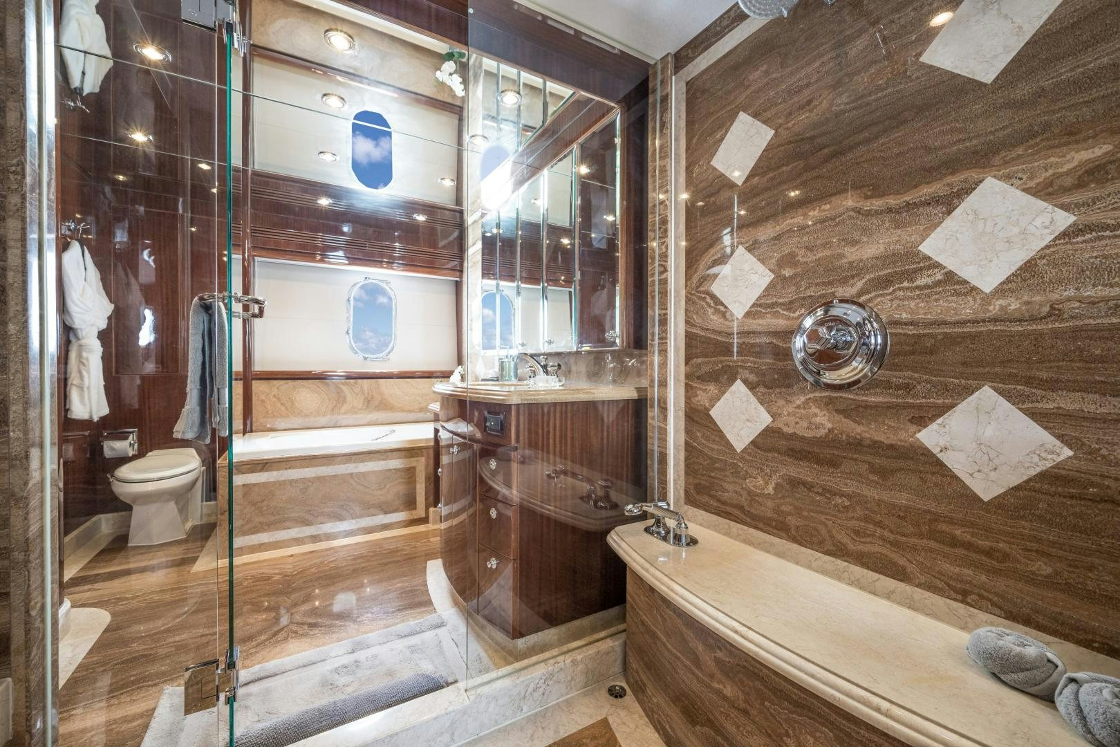a bathroom with a glass shower aboard LIMITLESS Yacht for Sale