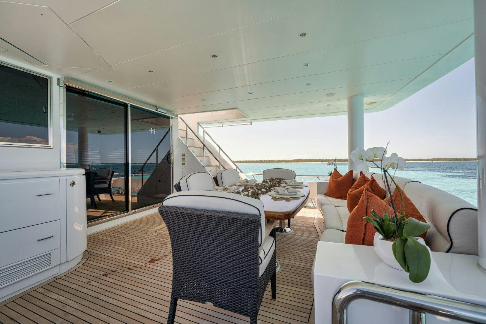 a boat with a table and chairs aboard LIMITLESS Yacht for Sale