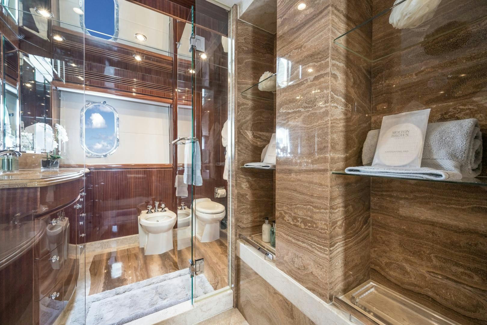 a bathroom with a glass shower aboard LIMITLESS Yacht for Sale