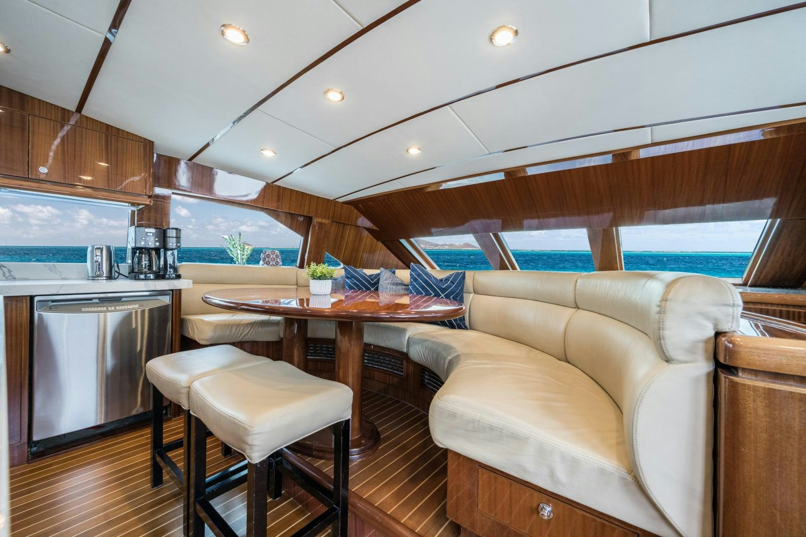 a kitchen with a table and chairs aboard LIMITLESS Yacht for Sale