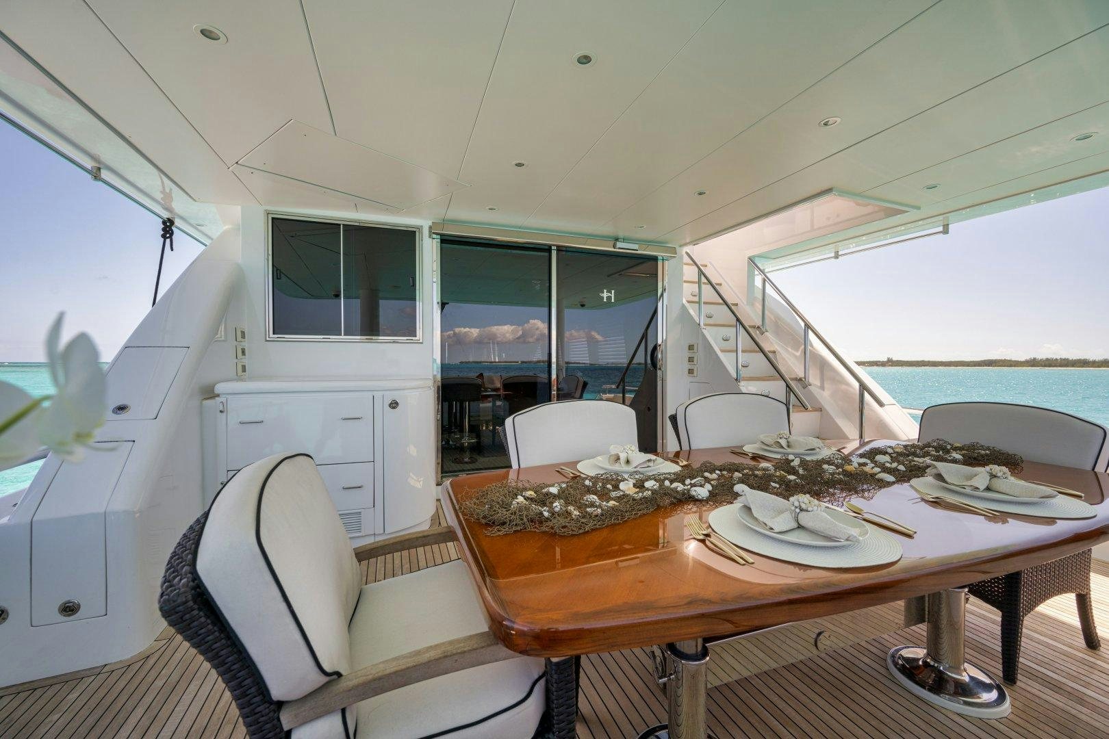 a table with plates on it aboard LIMITLESS Yacht for Sale