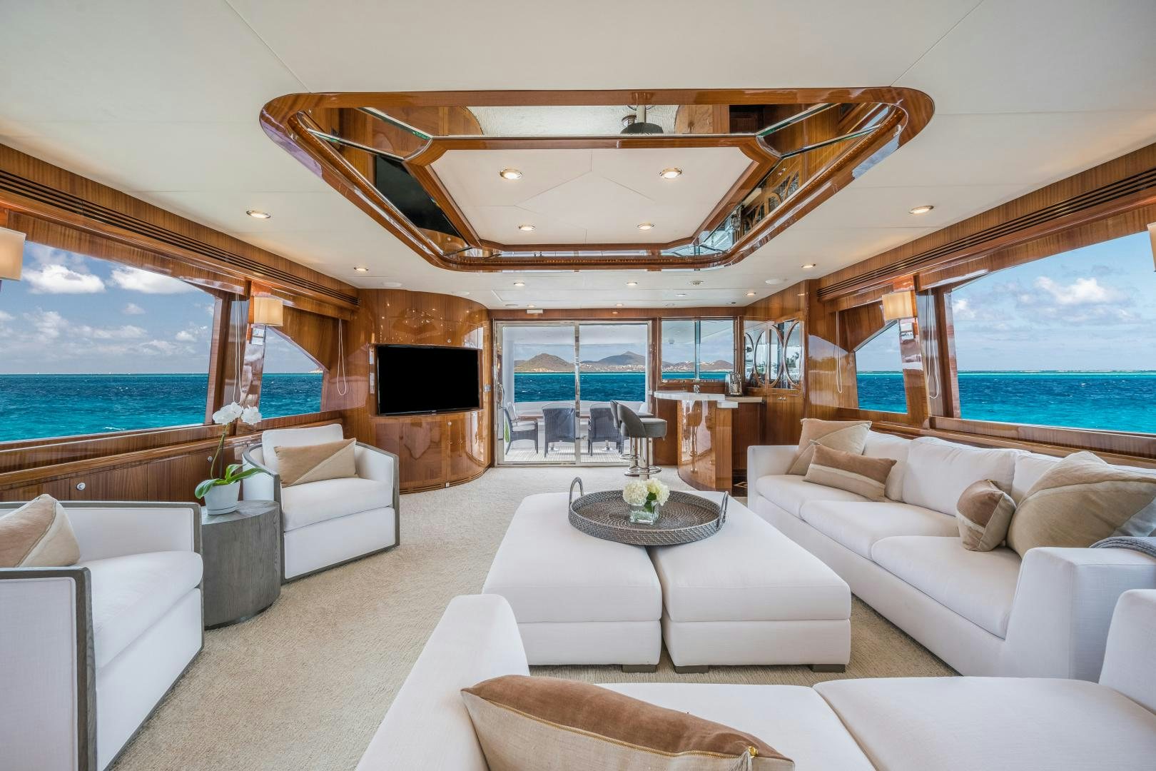 a living room with a large fireplace aboard LIMITLESS Yacht for Sale