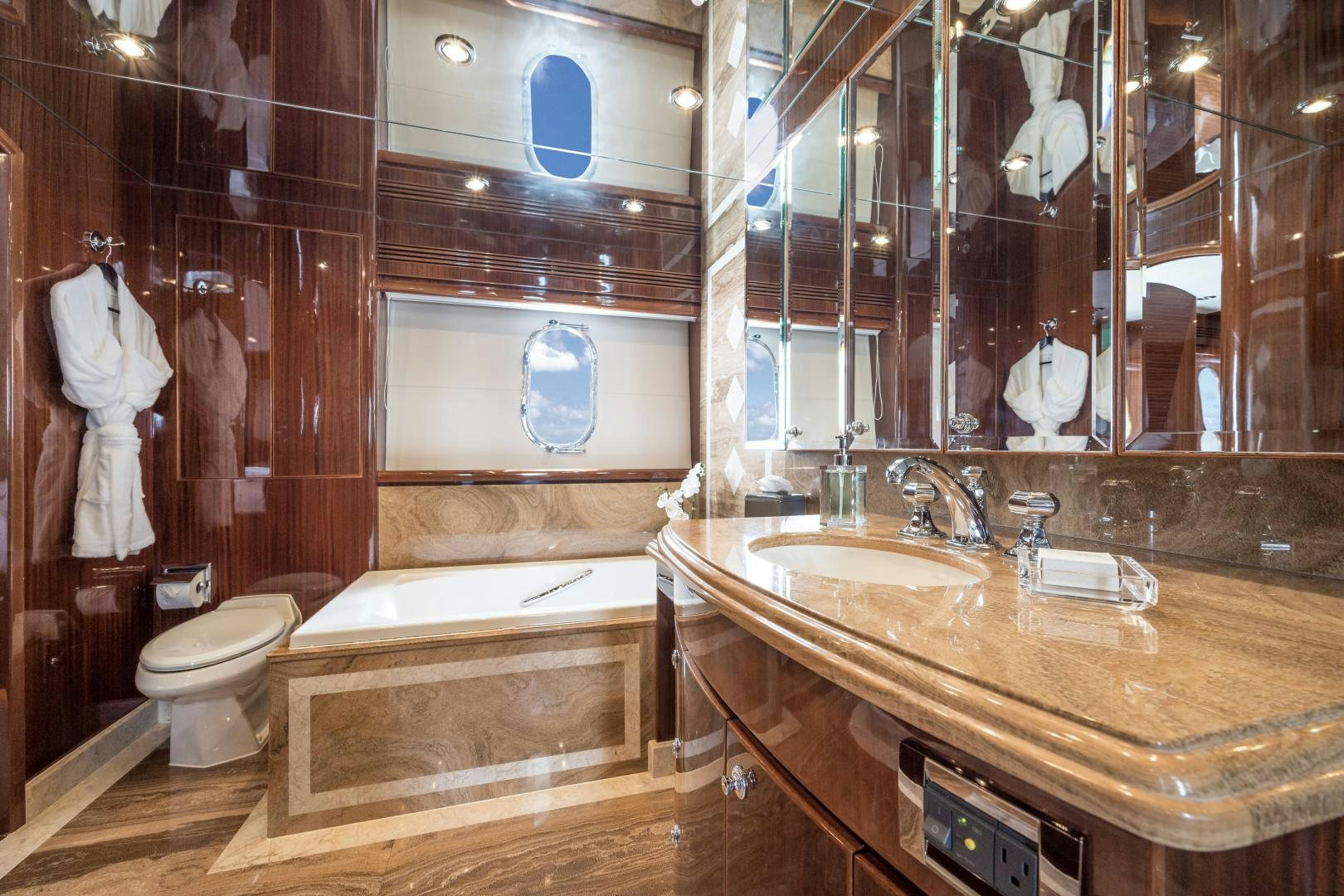 a bathroom with a large mirror aboard LIMITLESS Yacht for Sale