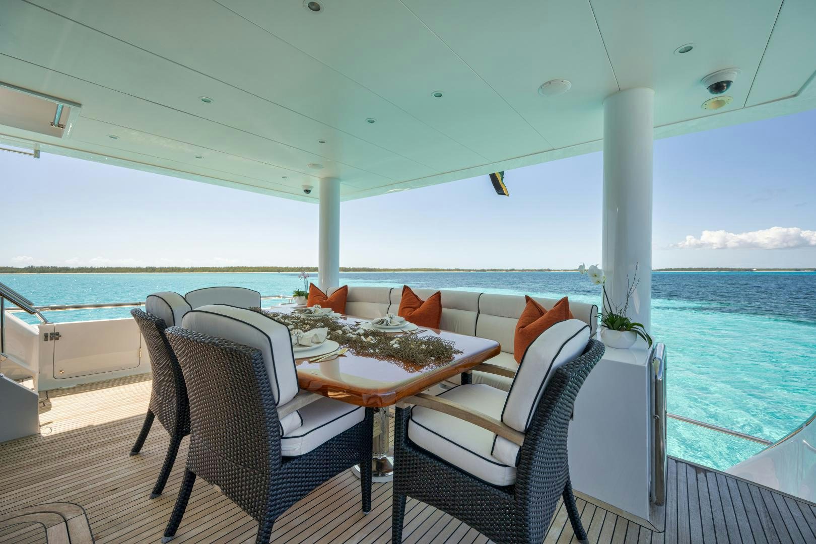 a table and chairs on a deck aboard LIMITLESS Yacht for Sale
