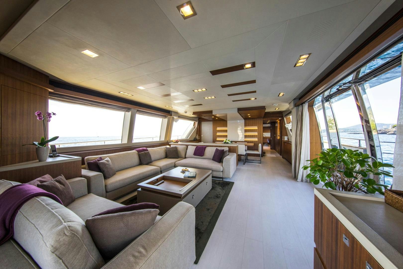a living room with a couch and a table aboard CAMPO VERDE Yacht for Sale