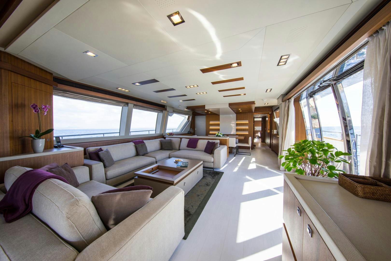 a living room with a couch and a table aboard CAMPO VERDE Yacht for Sale