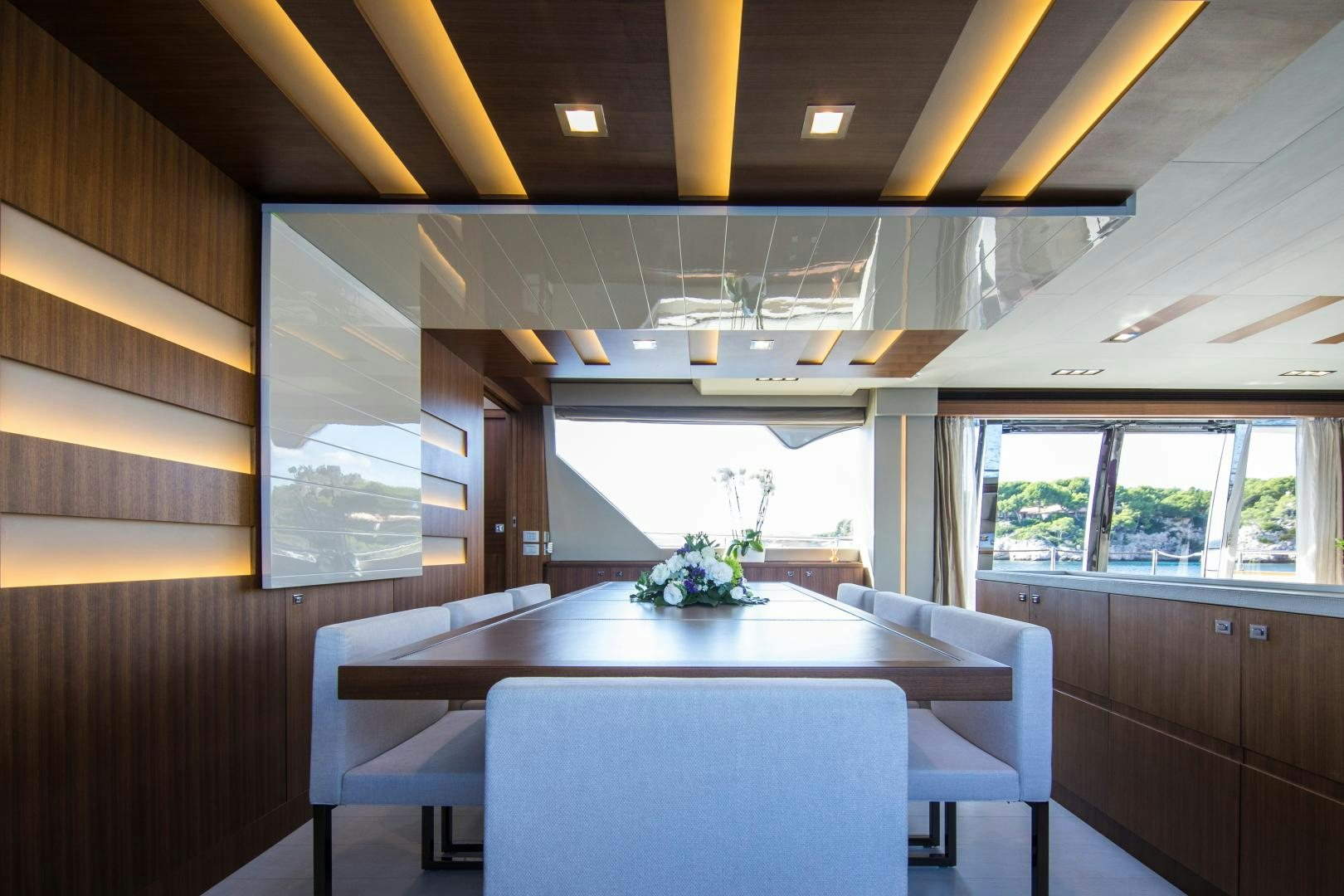 a room with a table and chairs aboard CAMPO VERDE Yacht for Sale