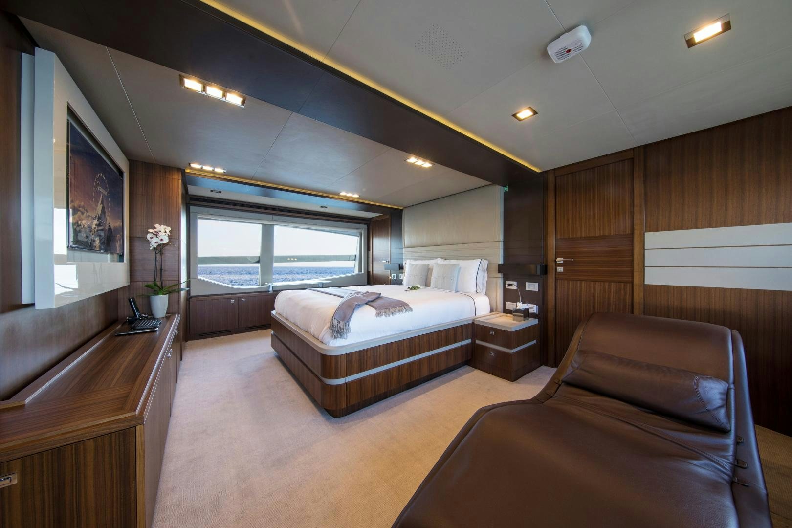 a bedroom with a bed and a couch aboard CAMPO VERDE Yacht for Sale