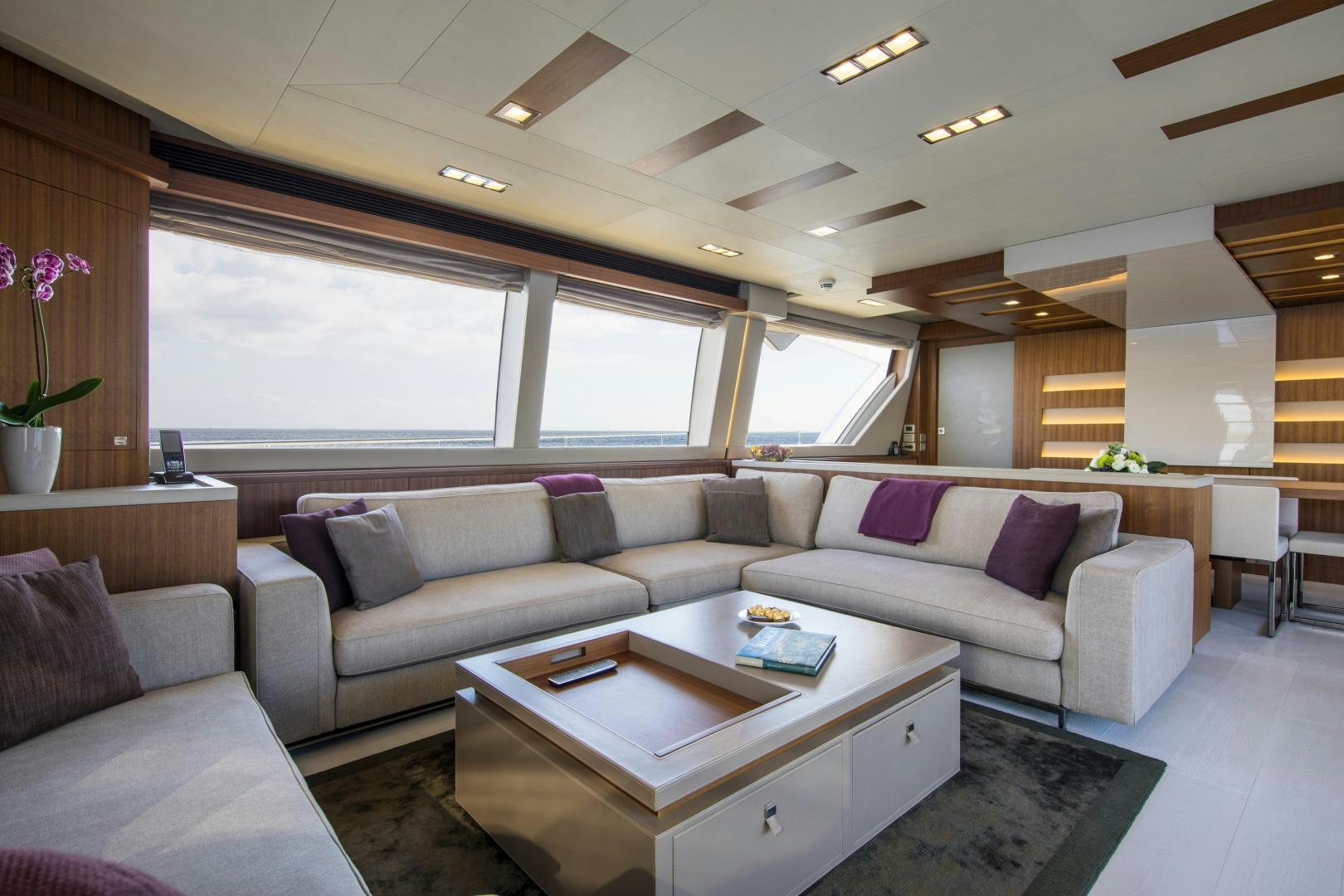 a living room with a couch and a coffee table aboard CAMPO VERDE Yacht for Sale
