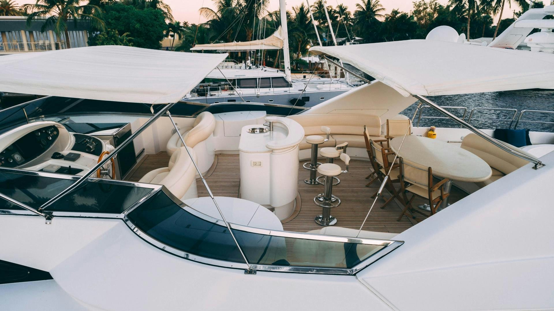 a boat with a table and chairs on it aboard CRISTALES Yacht for Sale