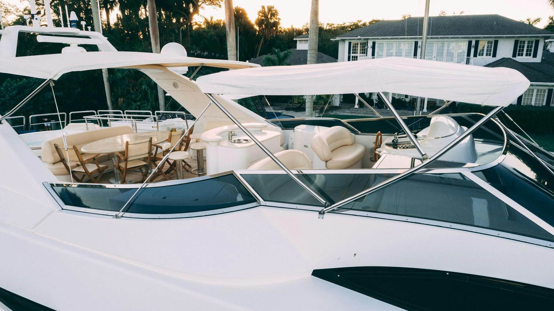 a white boat with a white canopy aboard CRISTALES Yacht for Sale