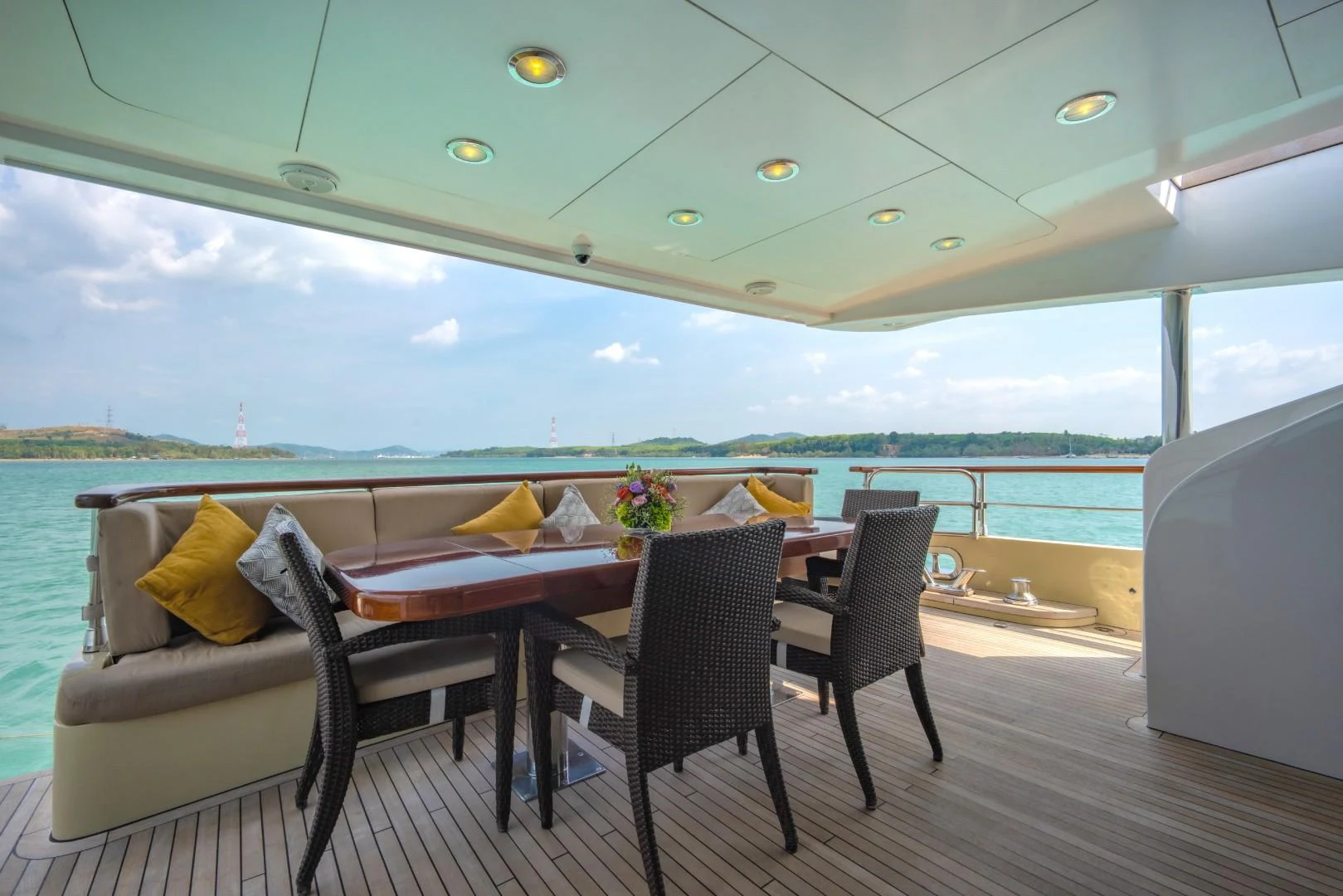 a table and chairs on a deck aboard MIA KAI Yacht for Sale