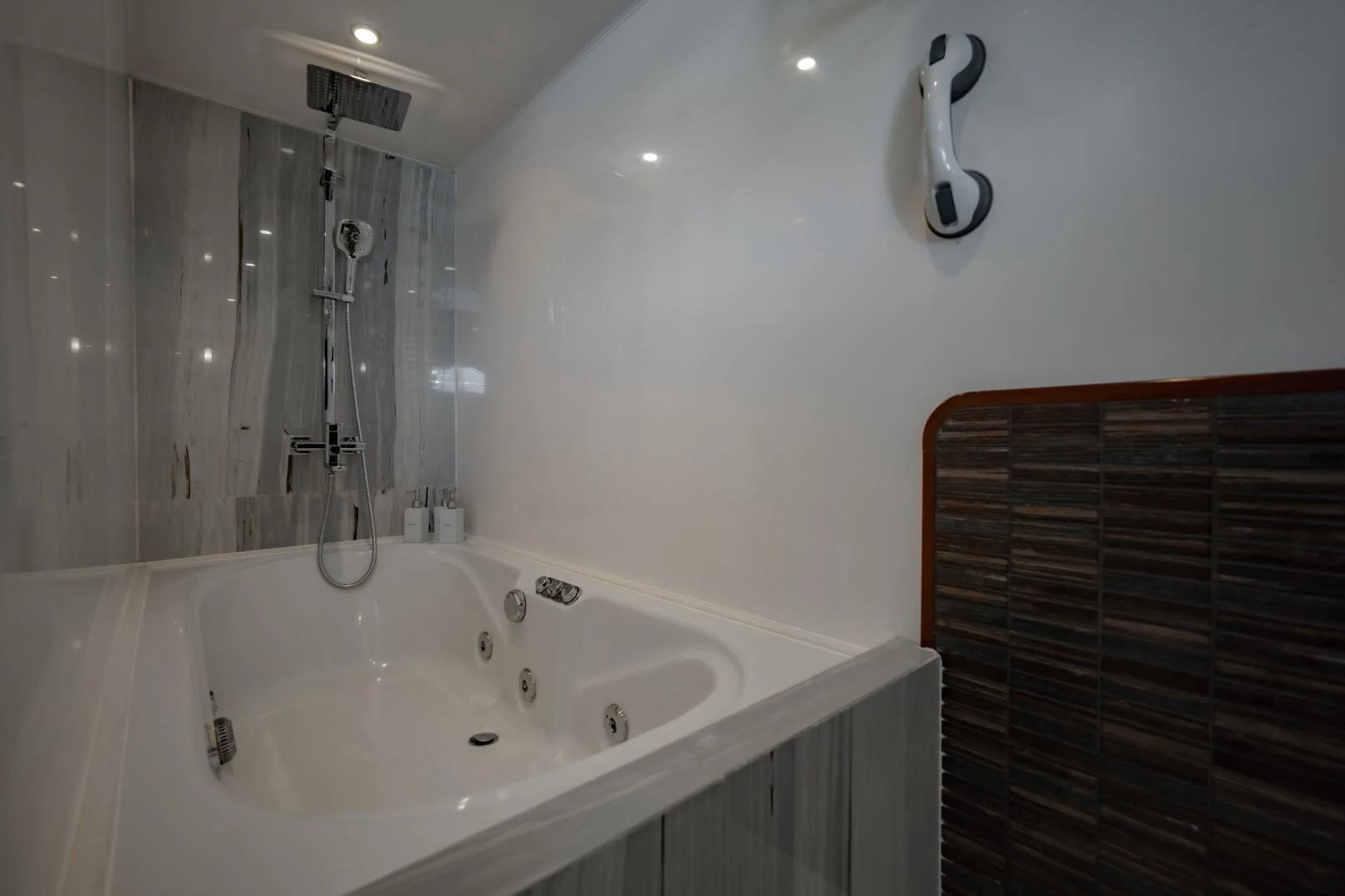 a bathtub with a shower head aboard MIA KAI Yacht for Sale
