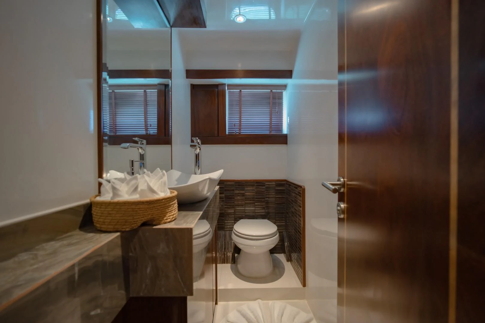 a bathroom with a sink toilet and a mirror aboard MIA KAI Yacht for Sale