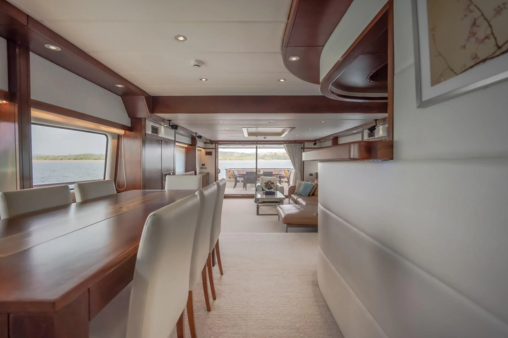a room with a large table and chairs aboard MIA KAI Yacht for Sale