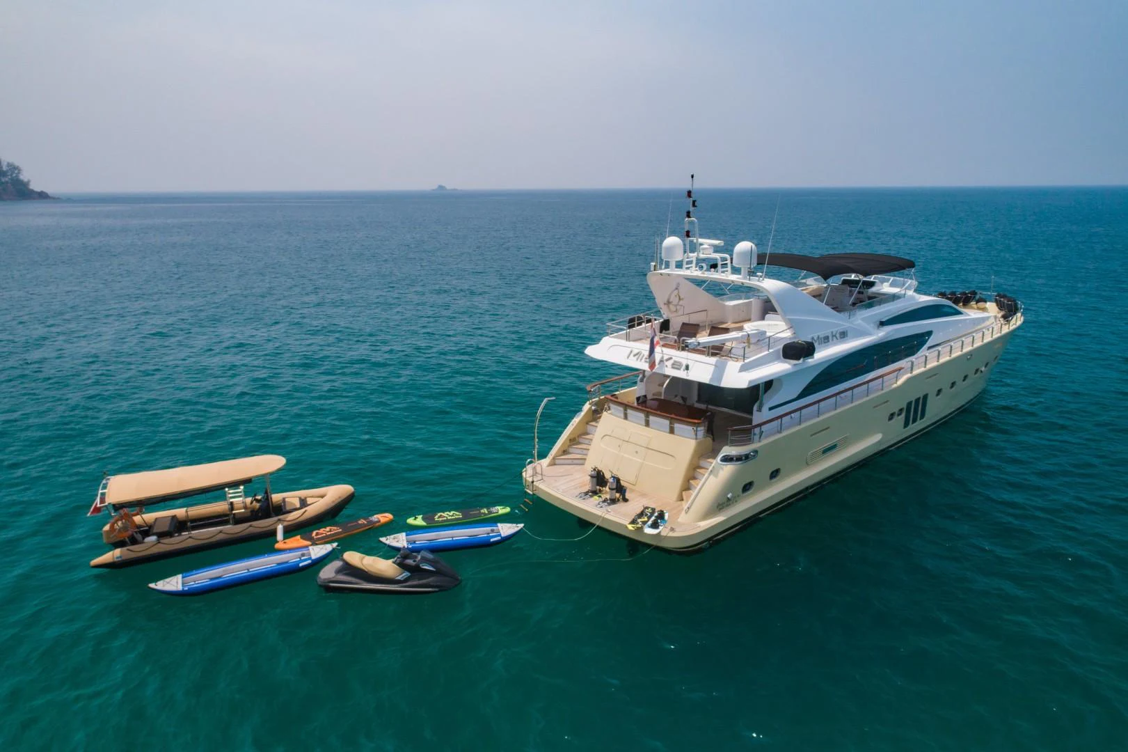 a large ship in the water aboard MIA KAI Yacht for Sale