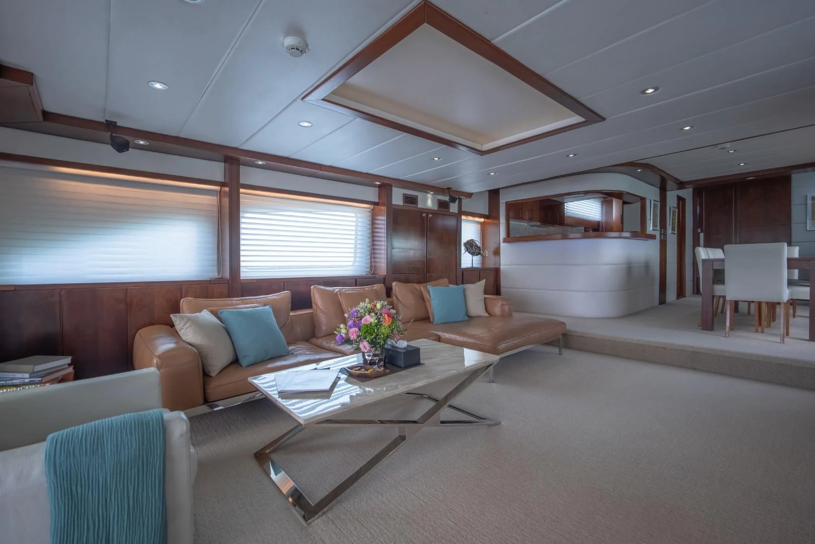 a living room with a couch and a table aboard MIA KAI Yacht for Sale