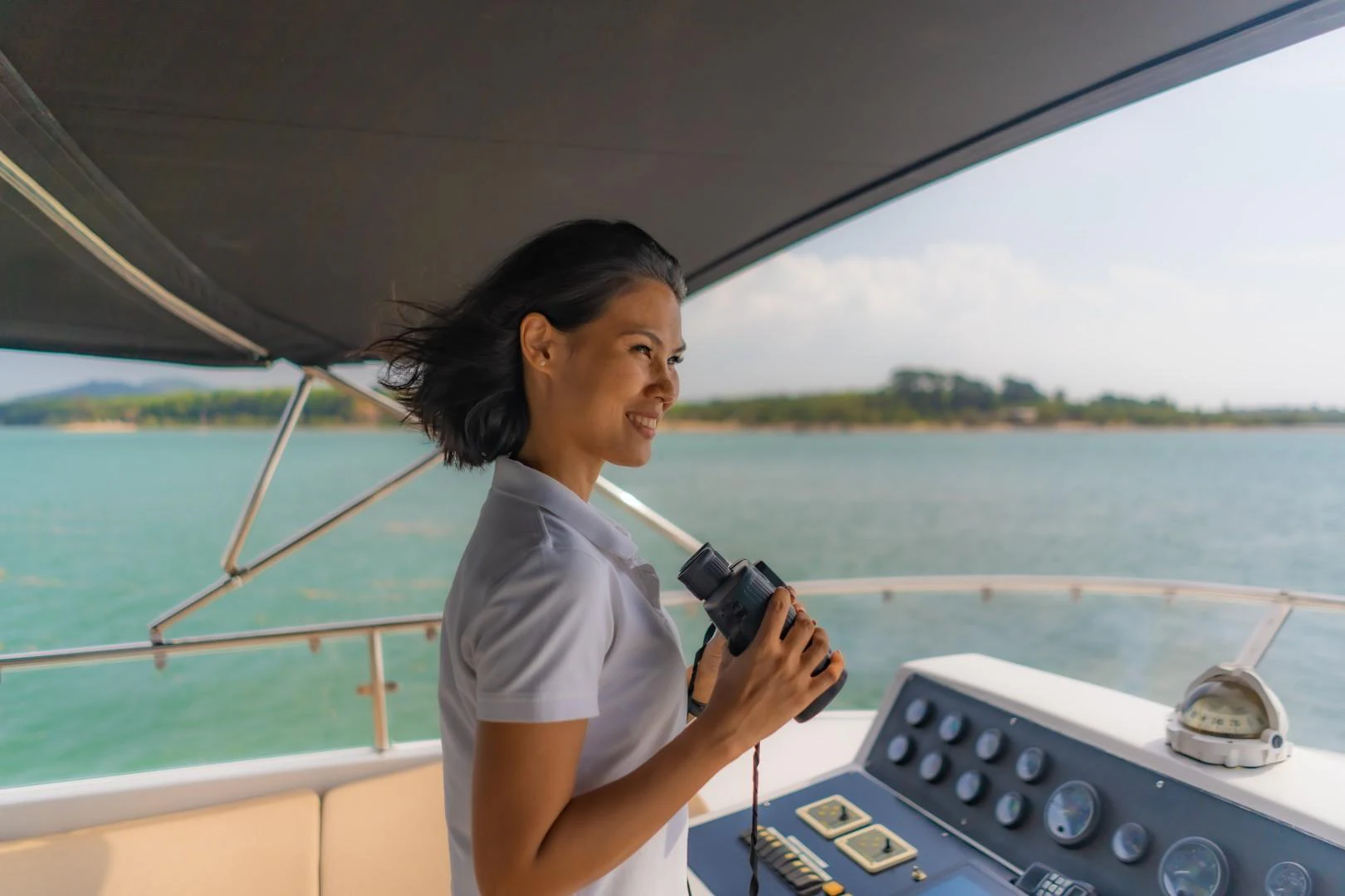 a person in a boat holding a camera aboard MIA KAI Yacht for Sale