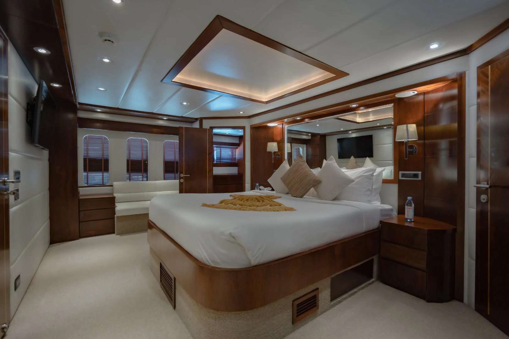a bedroom with a bed and a large ceiling aboard MIA KAI Yacht for Sale