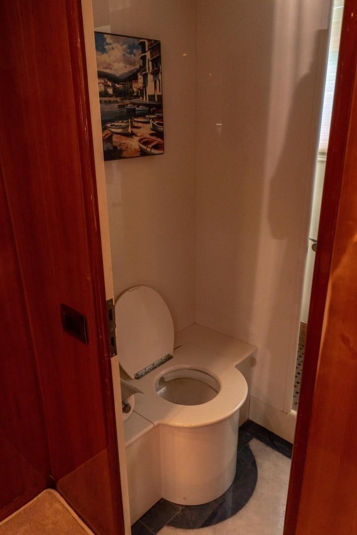 a toilet in a bathroom aboard EL CAPRICHO Yacht for Sale