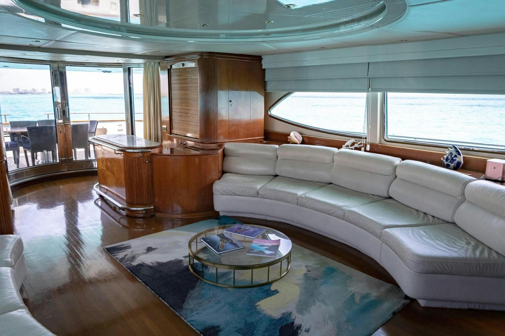 a living room with a couch and a table aboard EL CAPRICHO Yacht for Sale