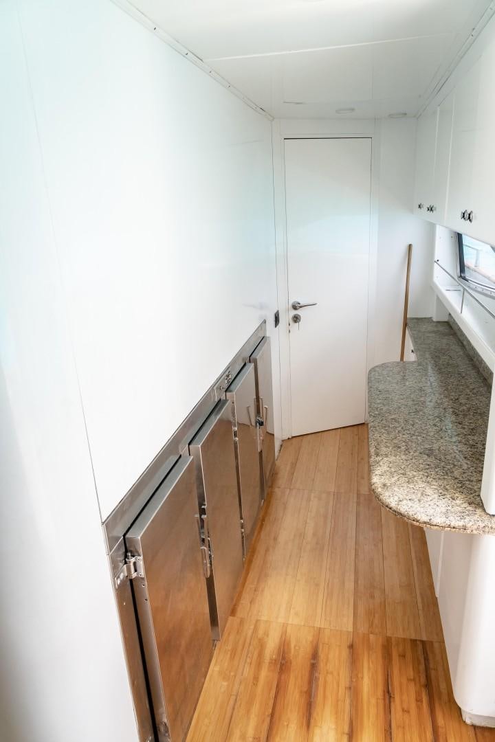 a kitchen with a wood floor aboard EL CAPRICHO Yacht for Sale