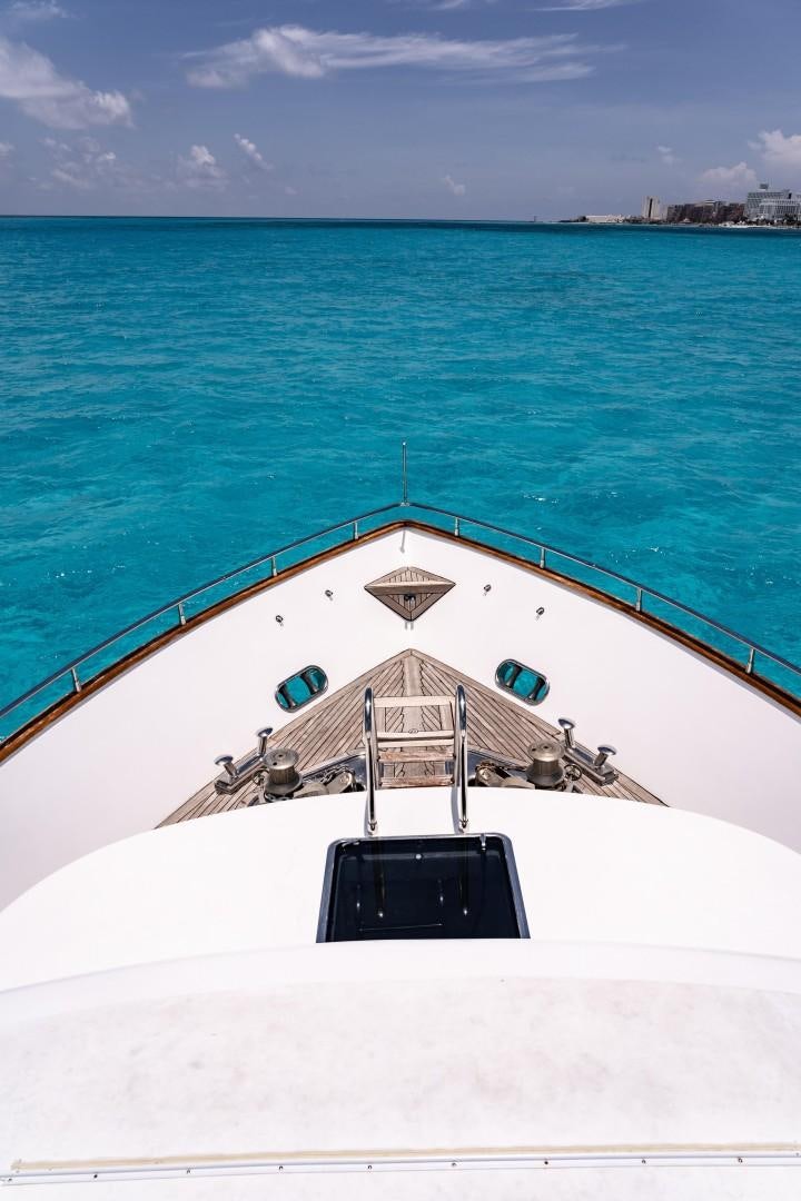 a white building with a black roof and a blue sky aboard EL CAPRICHO Yacht for Sale
