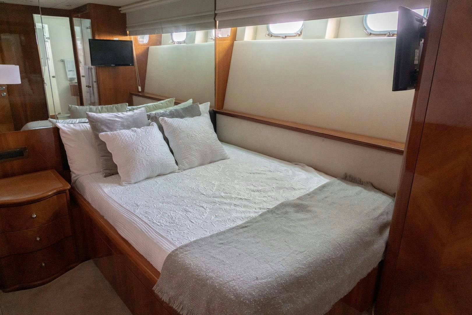 a bed with white sheets aboard EL CAPRICHO Yacht for Sale