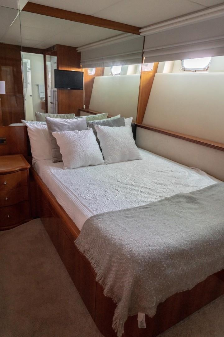 a bed with white sheets aboard EL CAPRICHO Yacht for Sale