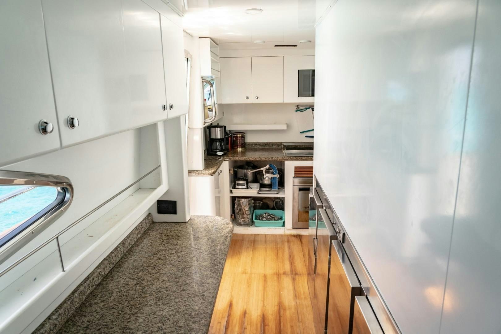 a kitchen with white cabinets aboard EL CAPRICHO Yacht for Sale
