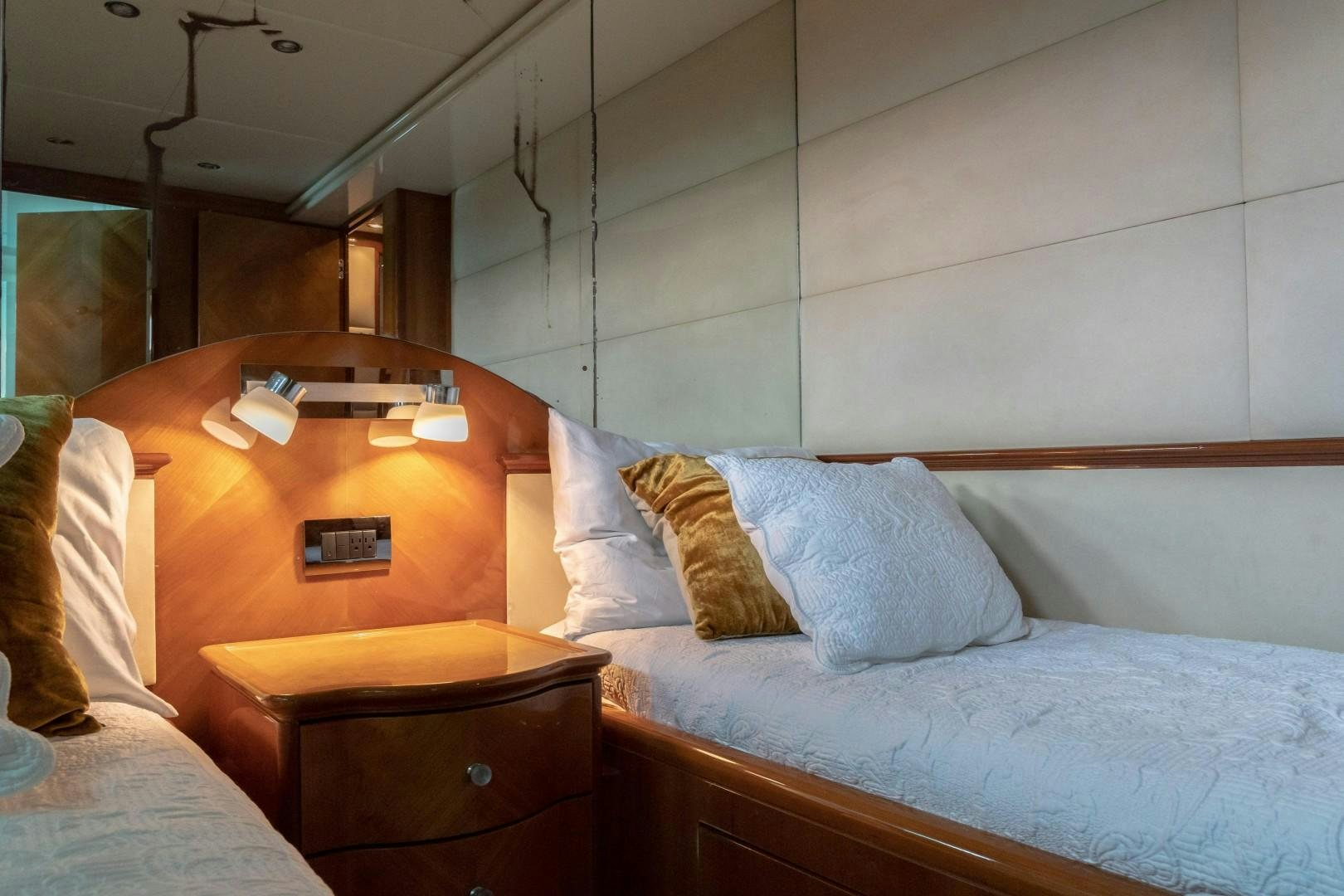 a bed with a white bed spread aboard EL CAPRICHO Yacht for Sale
