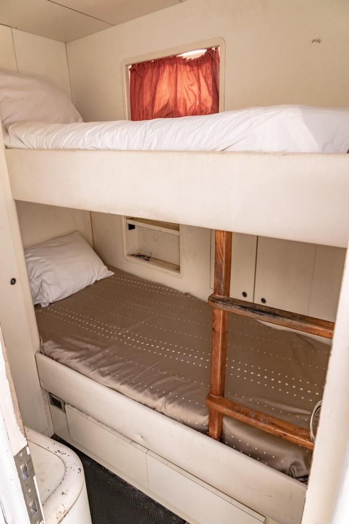 a bed with white sheets aboard EL CAPRICHO Yacht for Sale