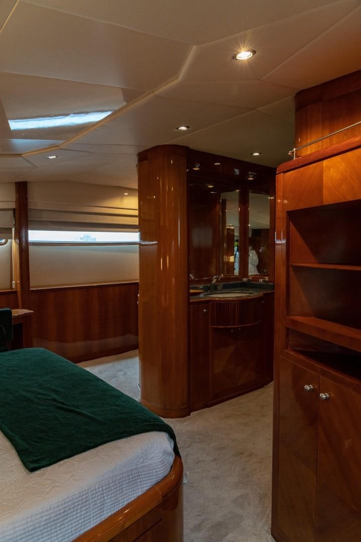 a bedroom with a bed and a closet aboard EL CAPRICHO Yacht for Sale