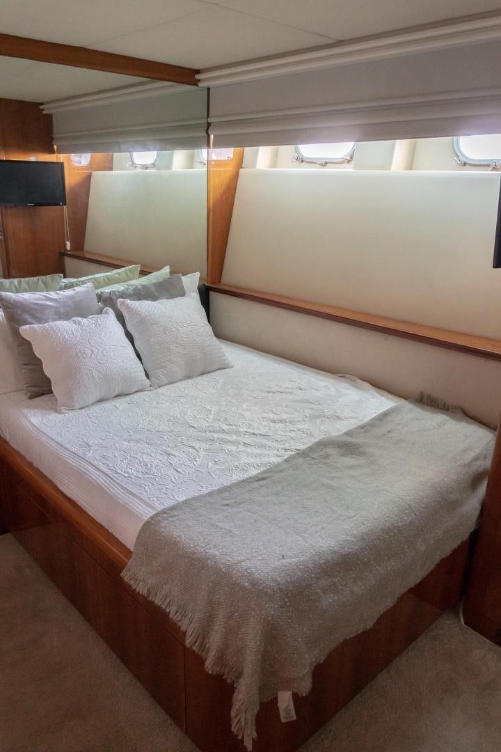 a bed with white sheets aboard EL CAPRICHO Yacht for Sale
