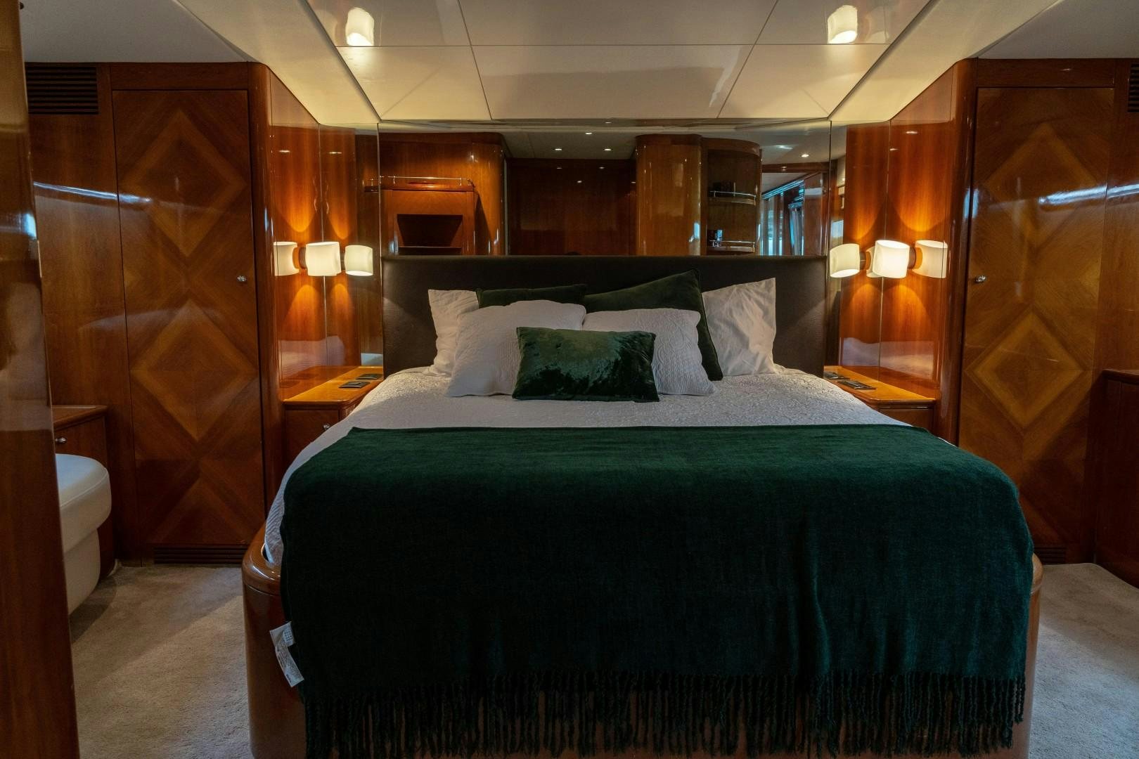 a bed with a black and white bed spread aboard EL CAPRICHO Yacht for Sale