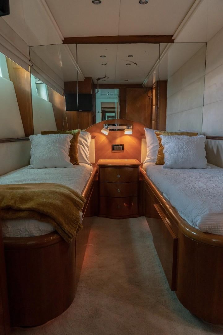 a room with beds and a desk aboard EL CAPRICHO Yacht for Sale