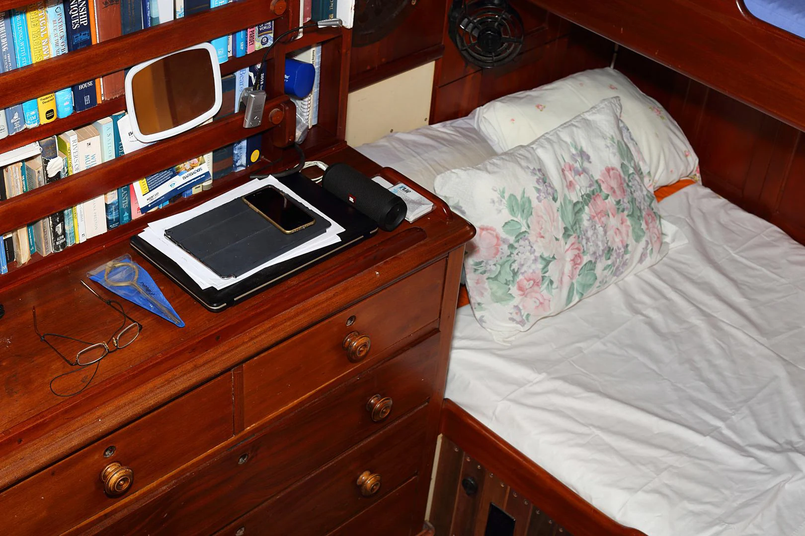 a bed with a television and a book shelf aboard SCHOONER RUTH Yacht for Sale