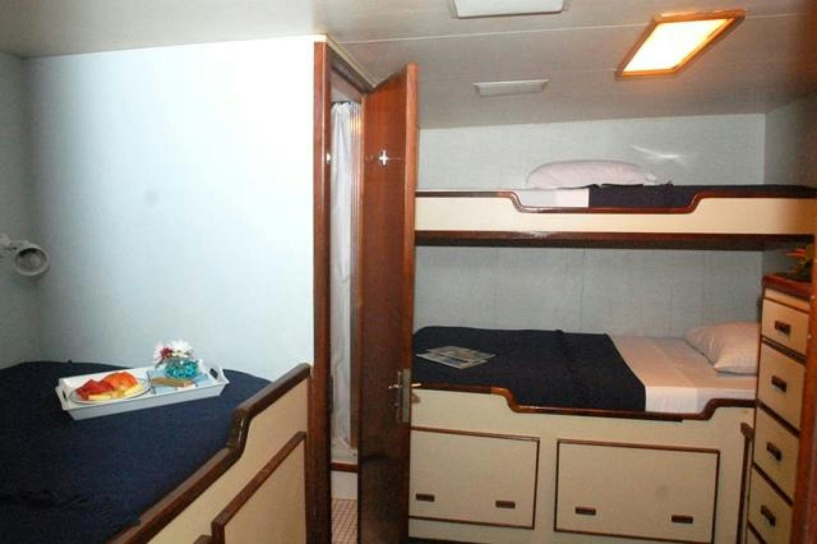 a room with a bed and a desk aboard No Name Yacht for Sale